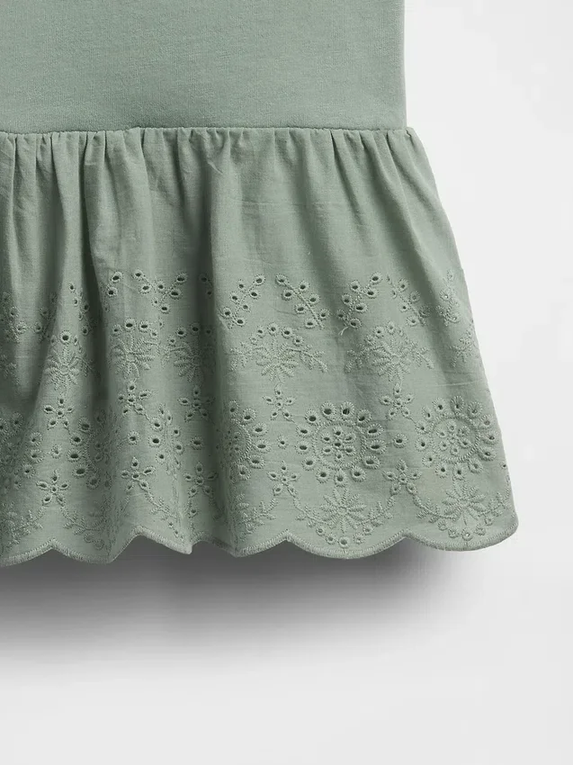 Blusa con dobladillo de ojales para bebés y niños pequeños