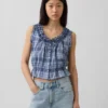 Blusa corta con peplum y lazo frontal con ojales