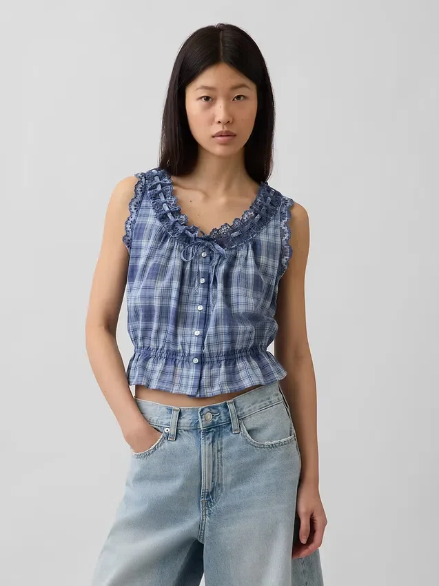 Blusa corta con peplum y lazo frontal con ojales