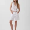 Blusa corta con peplum y lazo frontal con ojales