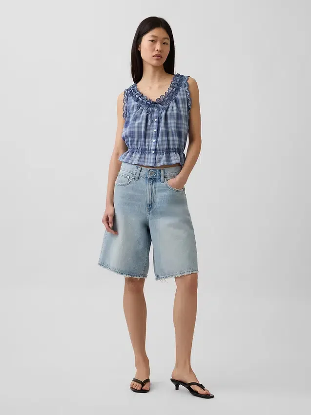 Blusa corta con peplum y lazo frontal con ojales
