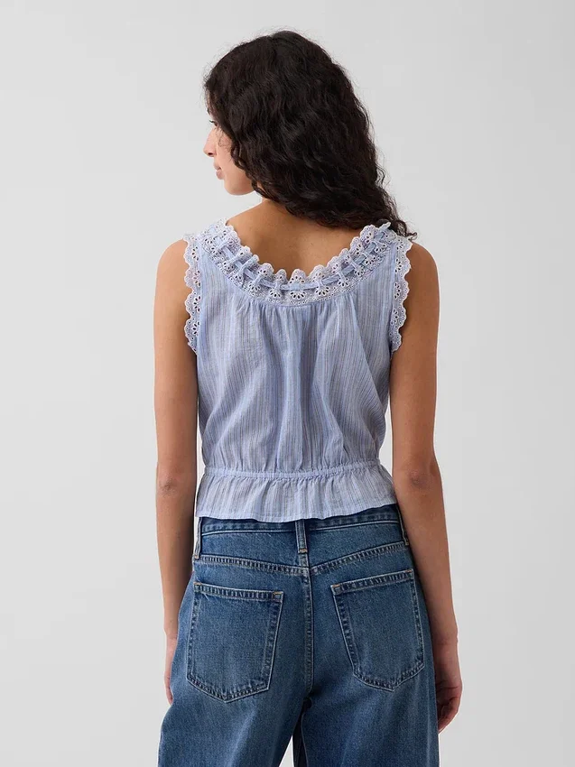 Blusa corta con peplum y lazo frontal con ojales