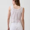 Blusa corta con peplum y lazo frontal con ojales