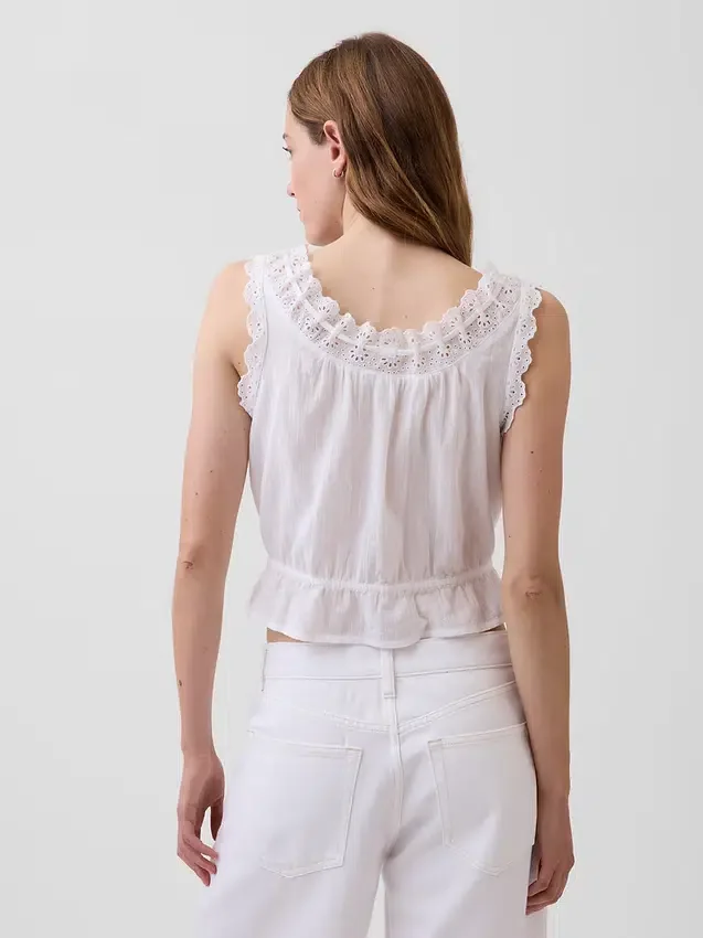 Blusa corta con peplum y lazo frontal con ojales