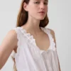 Blusa corta con peplum y lazo frontal con ojales