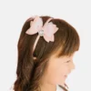 Diadema con moño brillante y dije de corazón de Sweet Wink