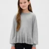 Jerséu infantil holgado con peplum