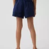 Pantalones cortos fáciles de poner para niños de lino y algodón con ribete de encaje
