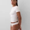 Tanga de algodón orgánico elástico con ribete de encaje