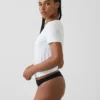 Tanga de algodón orgánico elástico con ribete de encaje