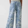 Vaqueros de mezclilla holgados de talle bajo con estampado floral para niños