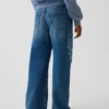 Vaqueros infantiles de talle bajo, corte amplio y estampado floral bordado